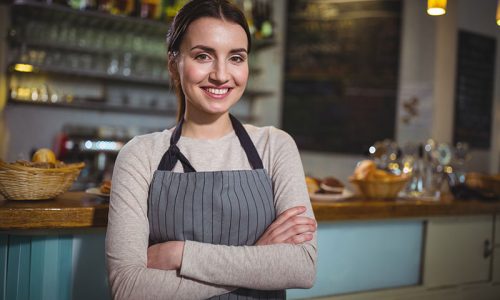 portrait-smiling-waitress-standing-counter Advanced Diploma of Hospitality Management